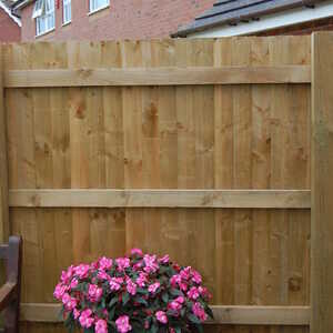 Featheredge timber fence with concrete gravel board