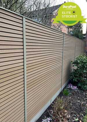 A modern wooden fence with horizontal slats and a green badge reading "DuraPost Elite Stockist."