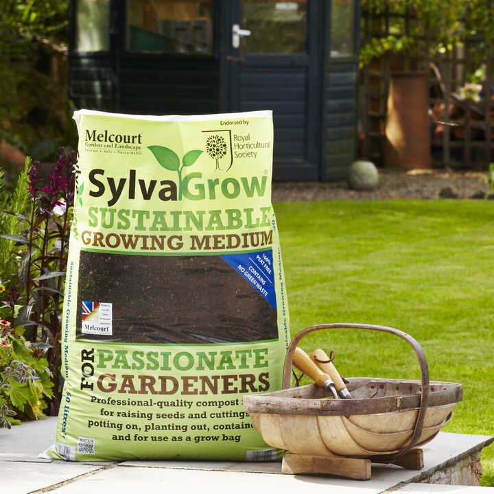 Sack of SylvaGrow sustainable growing medium next to a basket in a garden.