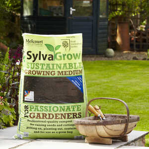 Sack of SylvaGrow sustainable growing medium next to a basket in a garden.