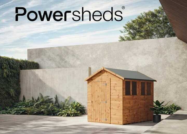 Powershed on a paved area with greenery in the background.